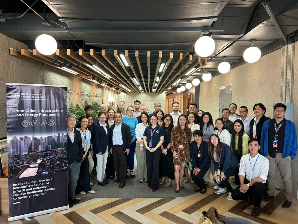 Manila GCIEP delegates gather for a series of workshops and meetings with key stakeholders - posing in the image with a GCIEP banner